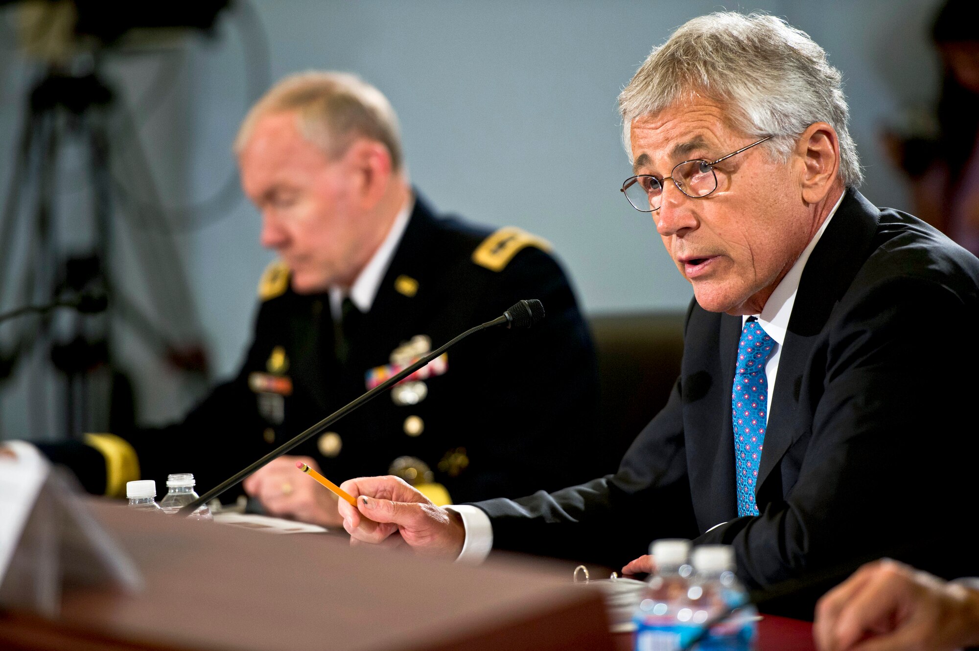 Defense Secretary Chuck Hagel reads his opening statement as he testifies on the Defense Department's fiscal year 2014 budget before the House Budget Committee in Washington, D.C., June 12, 2013. Army Gen. Martin E. Dempsey, chairman of the Joint Chiefs of Staff, joined Hagel in defending President Barack Obama's $526.6 billion budget request.( DOD photo by Erin A. Kirk-CuomoClose   The Pentagon Channel)
