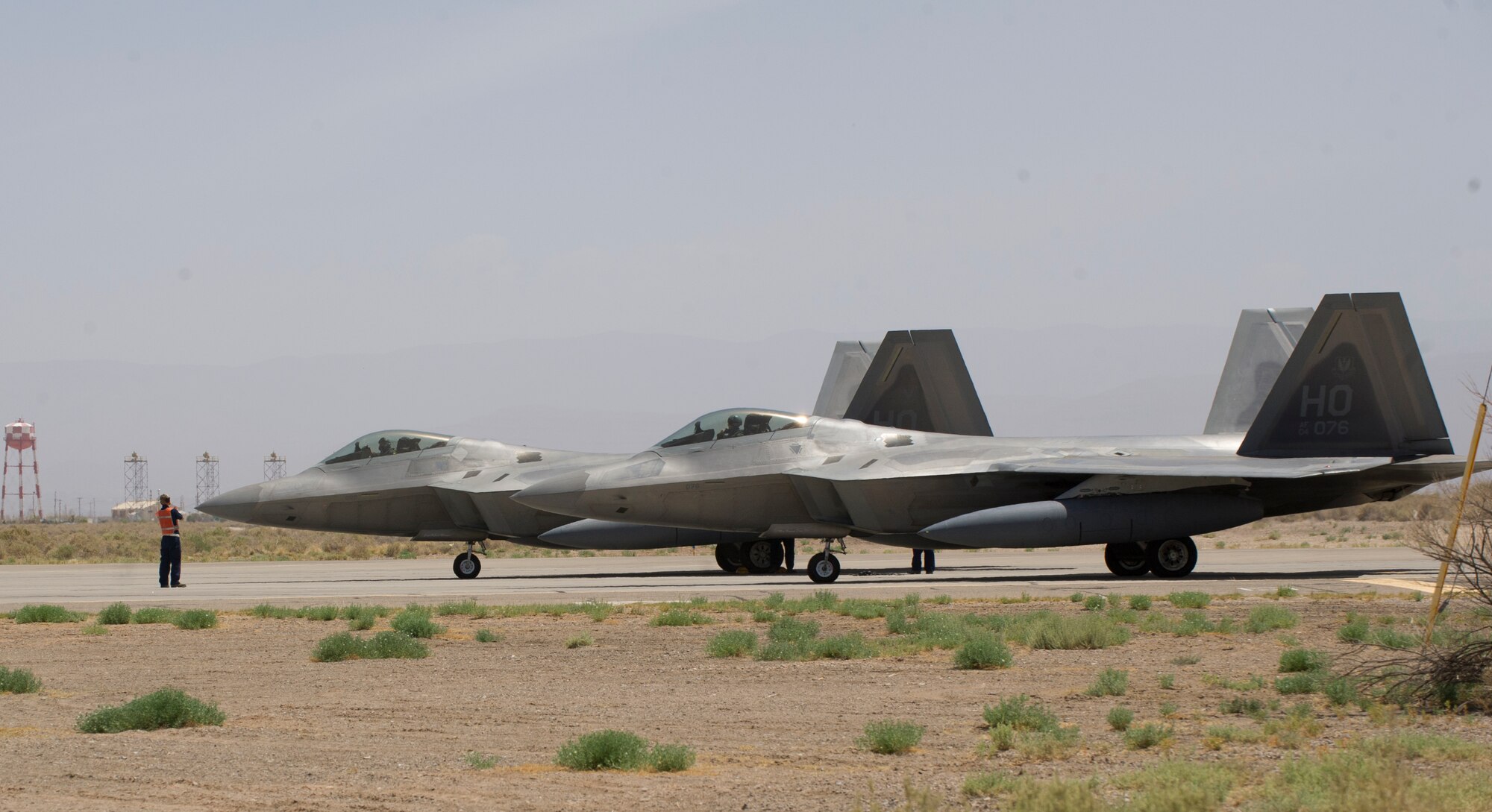 Two F-22 Raptors from the 7th Fighter Squadron prepare to take off at Holloman Air Force Base, N.M., June 8. The 7th FS flew F-22s in support of Operation Noble Eagle. ONE is the name given to the United States and Canadian military operations related to homeland security and support to federal, state, and local agencies. The ongoing operation began September 14, 2001, in response to the September 11 attacks. (U.S. Air Force photo by Airman 1st Class Chase Cannon/Released)