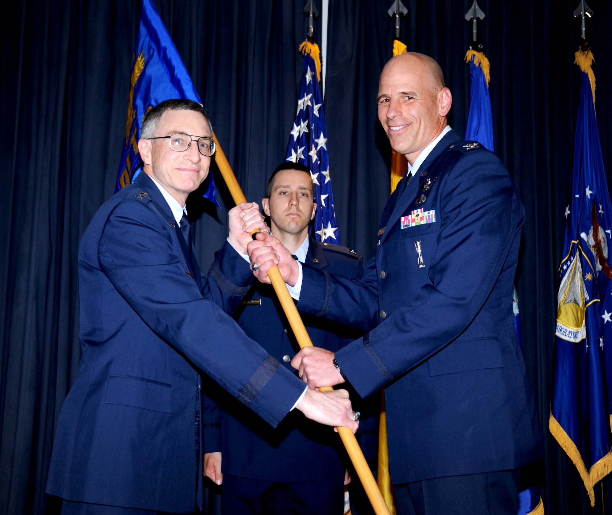 Maj. Gen. William McCasland, Air Force Research Laboratory commander, left, presents the guidon to Col. David Goldstein, the new director of AFRL’s Space Vehicles Directorate and commander of the Phillips Research Site, during an change of command ceremony June 10 at the Mountain View Club. (Photo by Todd Berenger)