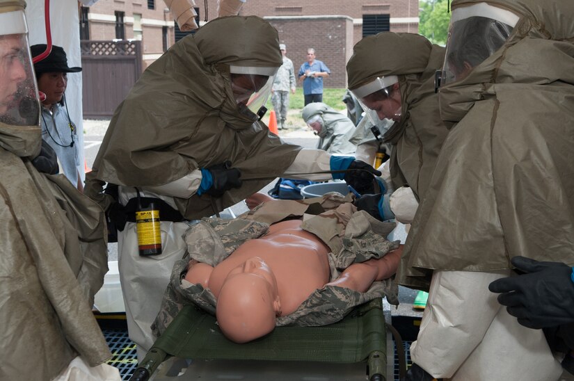 Members of the 87th Medical Group Chemical, Biological, Radiological, and Nuclear Defense response team participate in a timed exercise to decontaminate patients May 30, 2013, on Joint Base McGuire-Dix-Lakehurst, N.J. The timed test run is used to train for peacetime CBRN response of contaminated patients that may present to the 87th MDG. (U.S. Air Force photo by Wayne Russell/Released) 