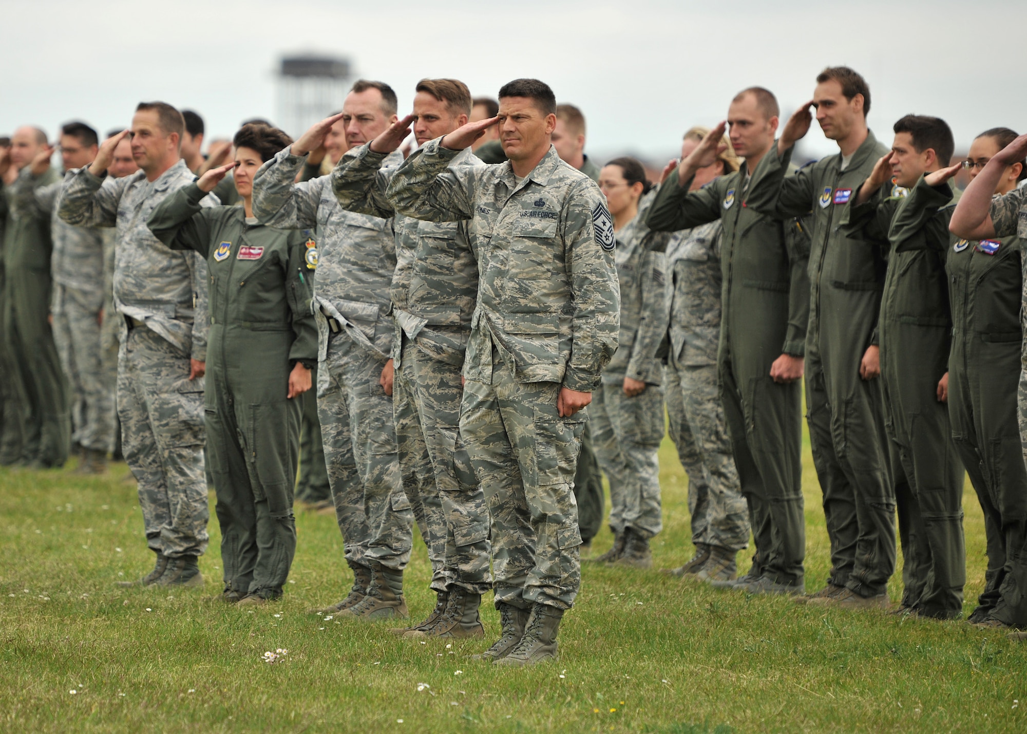 Team Mildenhall members render a salute as a KC-135 Stratotanker, piloted by Col. Christopher Kulas, 100th Air Refueling Wing commander, taxis on the flightline June 12, 2013, at RAF Mildenhall, England. Team Mildenhall members, along with Kulas’ family and friends, greeted him upon landing to celebrate his final flight before departing RAF Mildenhall. (U.S. Air Force photo by Staff Sgt. Jerilyn Quintanilla/Released)  