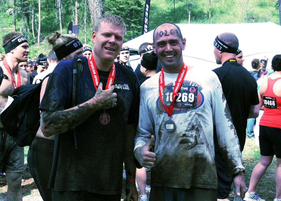 Race participants pose with their medals at the finish of the 2013 Spartan Sprint held near Bigfork, Mont. May 11. (U.S. Air Force photo/Tech. Sgt Brett McCloney)