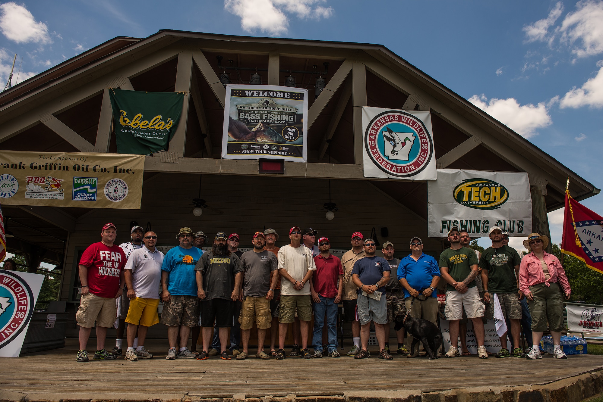 Wounded warriors and boat captains pose for a group photo at the conclusion of the first annual Wounded Warrior Project bass fishing tournament June 8, 2013, at Lake Dardanelle, Ark. The Wounded Warrior Project serves veterans and service members, and their families, who incurred physical or mental injuries, illnesses, or wounds, co-incident to their military service on or after September 11, 2001.  (U.S. Air Force photo by Staff Sgt. Russ Scalf)