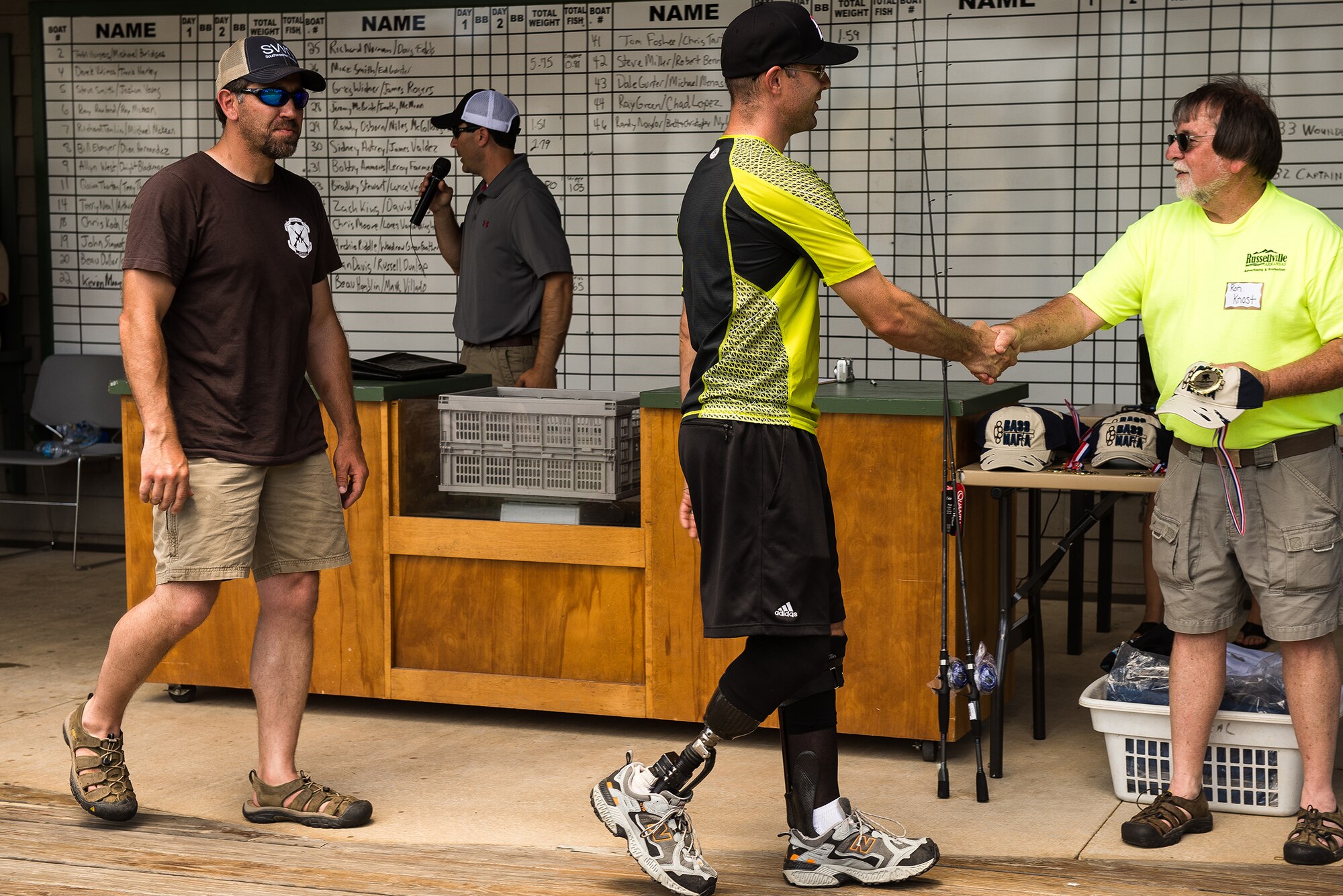 A team receives prizes for participating in the first annual Wounded Warrior Project bass fishing tournament June 8, 2013, at Lake Dardanelle, Ark. The tournament, held in cooperation with the Arkansas Wildlife Federation, partnered wounded veterans with local volunteer boat captains for a day of relaxation on the lake. (U.S. Air Force photo by Staff Sgt. Russ Scalf)