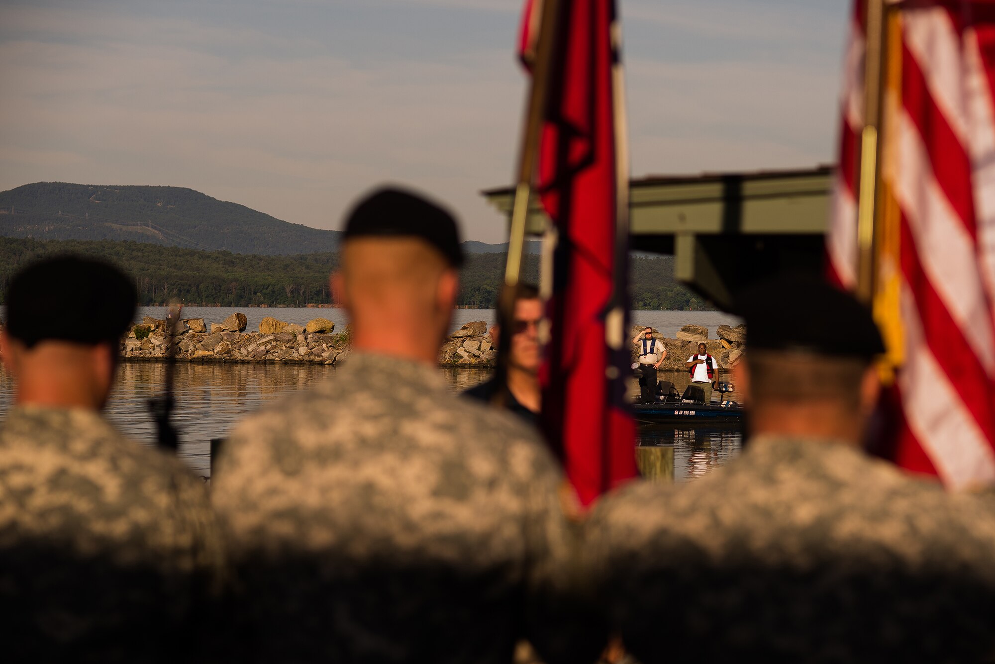 Participants of the Wounded Warrior Project Bass Fishing Tournament observe the singing of the national anthem June 8, 2013, at Lake Dardanelle, Ark. The tournament was held in honor of service members who served in the Iraq and Afghanistan military operations. (U.S. Air Force photo by Staff Sgt. Russ Scalf)