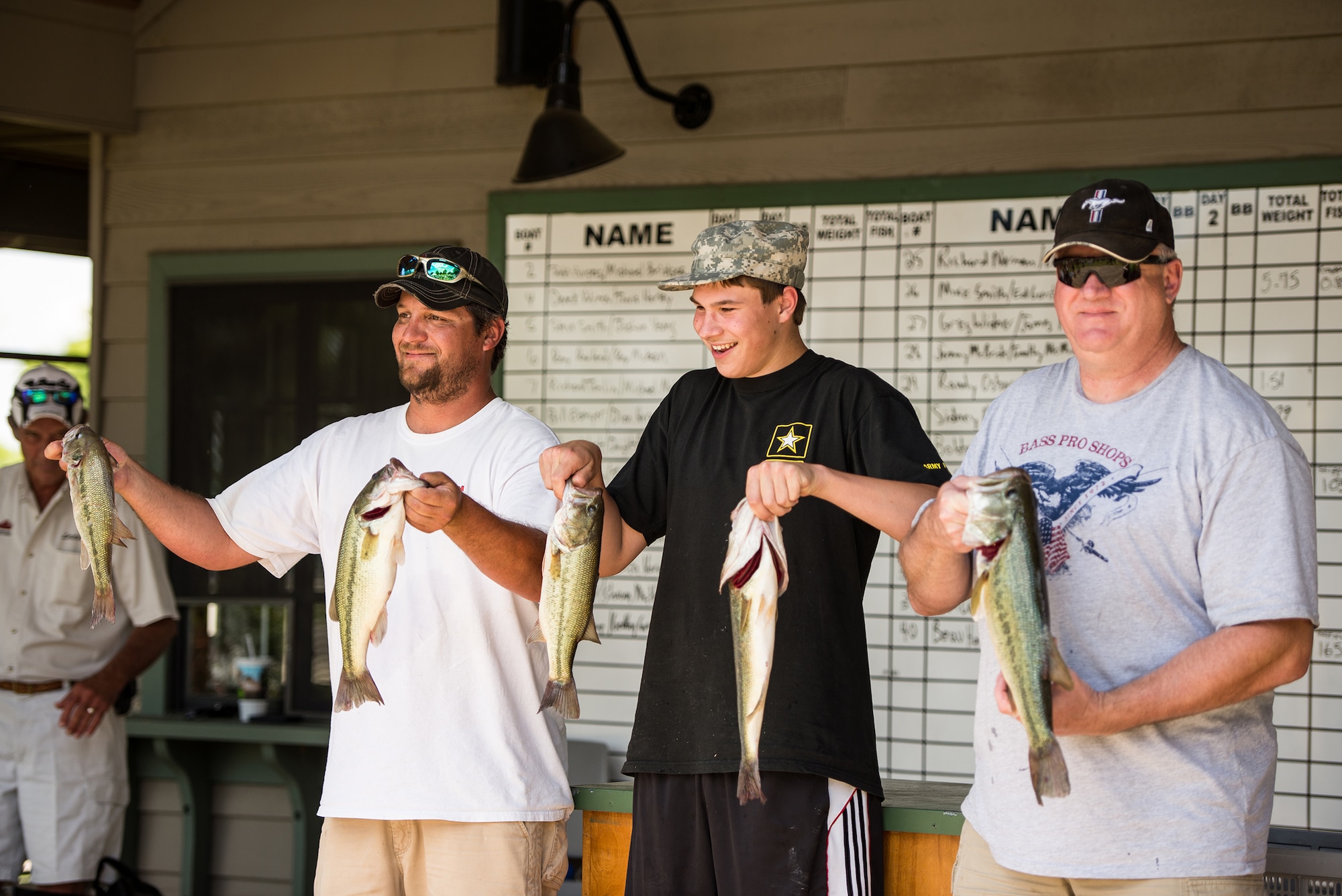 Participants display their catch at the weigh-ins of the first annual Wounded Warrior Project bass fishing tournament June 8, 2013, at Lake Dardanelle, Ark. The team took home first place with nearly 14 lbs. of bass.  (U.S. Air Force photo by Staff Sgt. Russ Scalf)