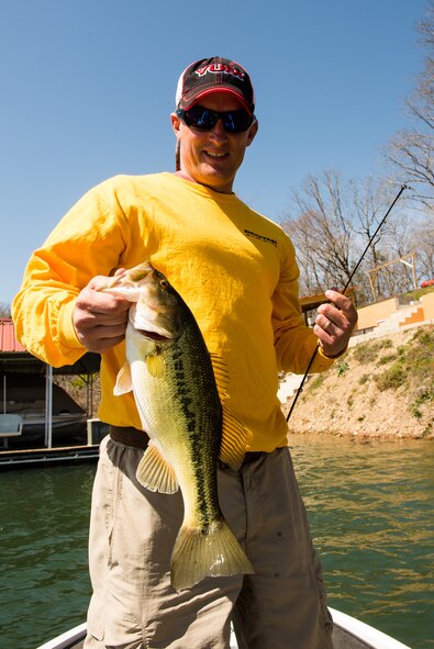 Master Sgt. Jeff Wade admires a bass before releasing it March 15, 2013, at Lake Hamilton, Ark. Wade was the angler of the year for the 2012 Toyota Bassmaster Weekend Series, operated by American Bass Anglers, for the Arkansas Division. (U.S. Air Force photo/Staff Sgt. Russ Scalf)