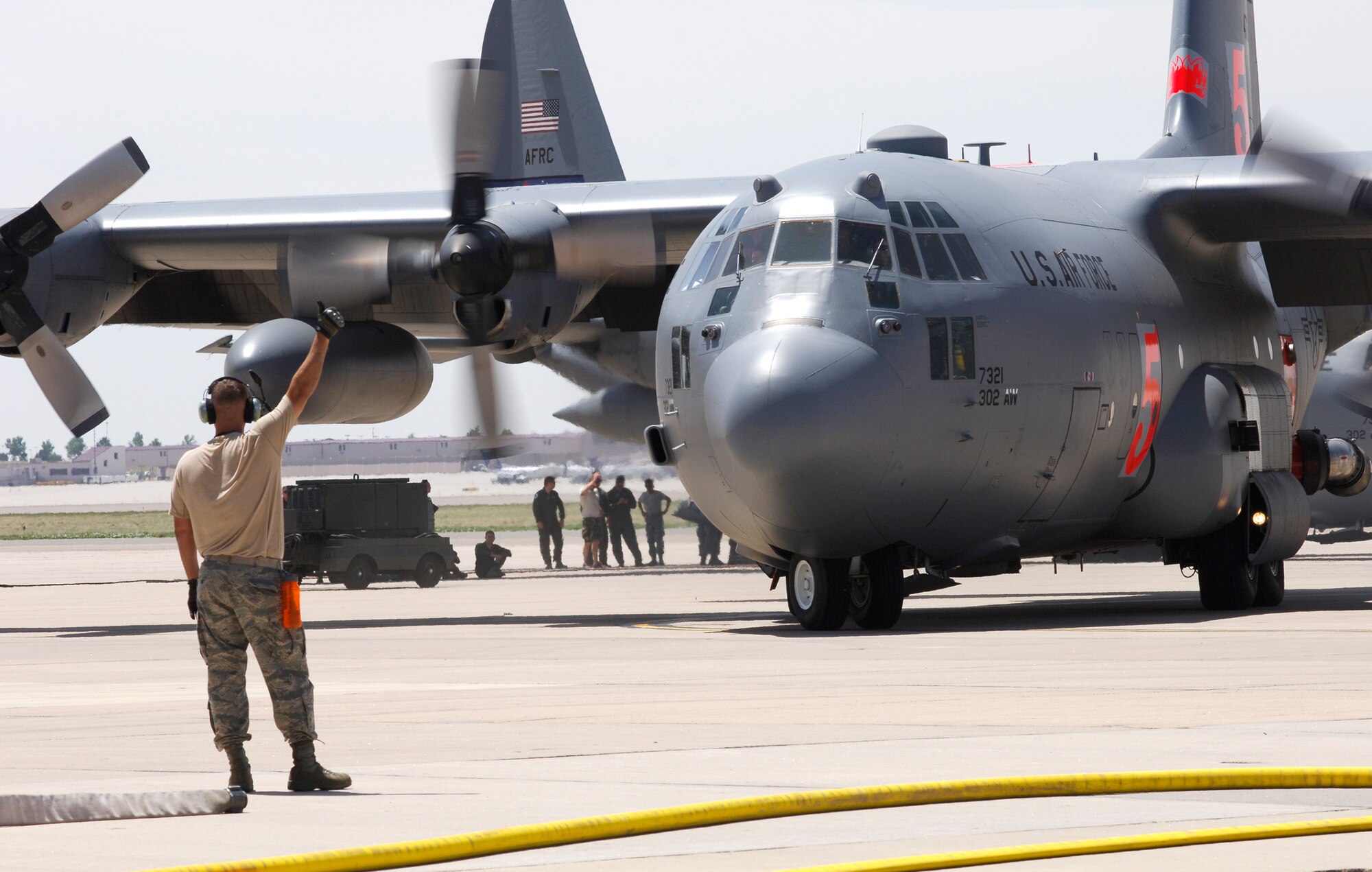 Two Modular Airborne Firefighting System-equipped C-130s from the Air Force Reserve's 302nd Airlift Wing prepare to take flight June 12 at Peterson Air Force Base, Colo. The aircraft and their aircrews have been assigned to provide MAFFS support to wildland firefighting efforts in Colorado. (U.S. Navy photo/Lt. Cmdr. William Lewis)
