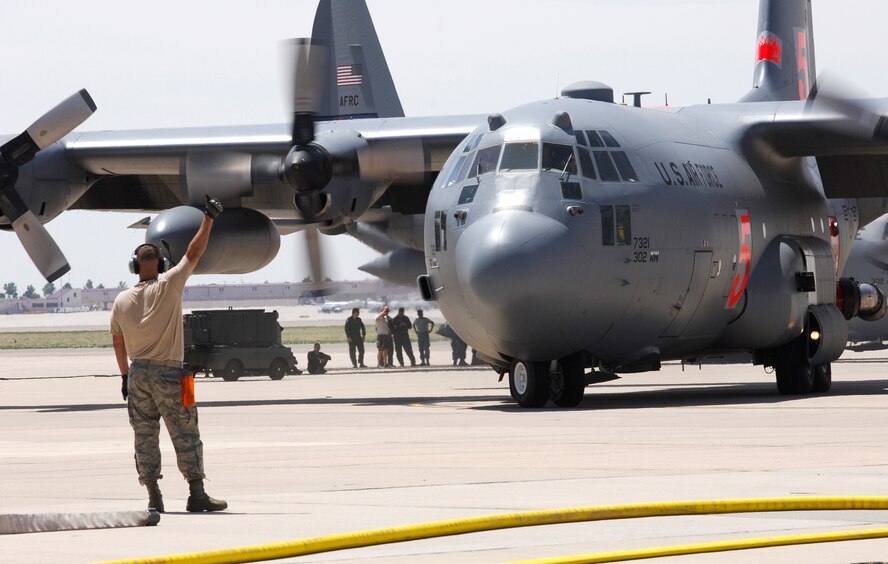 Two Modular Airborne Firefighting System-equipped C-130s from the Air Force Reserve's 302nd Airlift Wing prepare to take flight June 12 at Peterson Air Force Base, Colo. The aircraft and their aircrews have been assigned to provide MAFFS support to wildland firefighting efforts in Colorado. (U.S. Navy photo/Lt. Cmdr. William Lewis)
