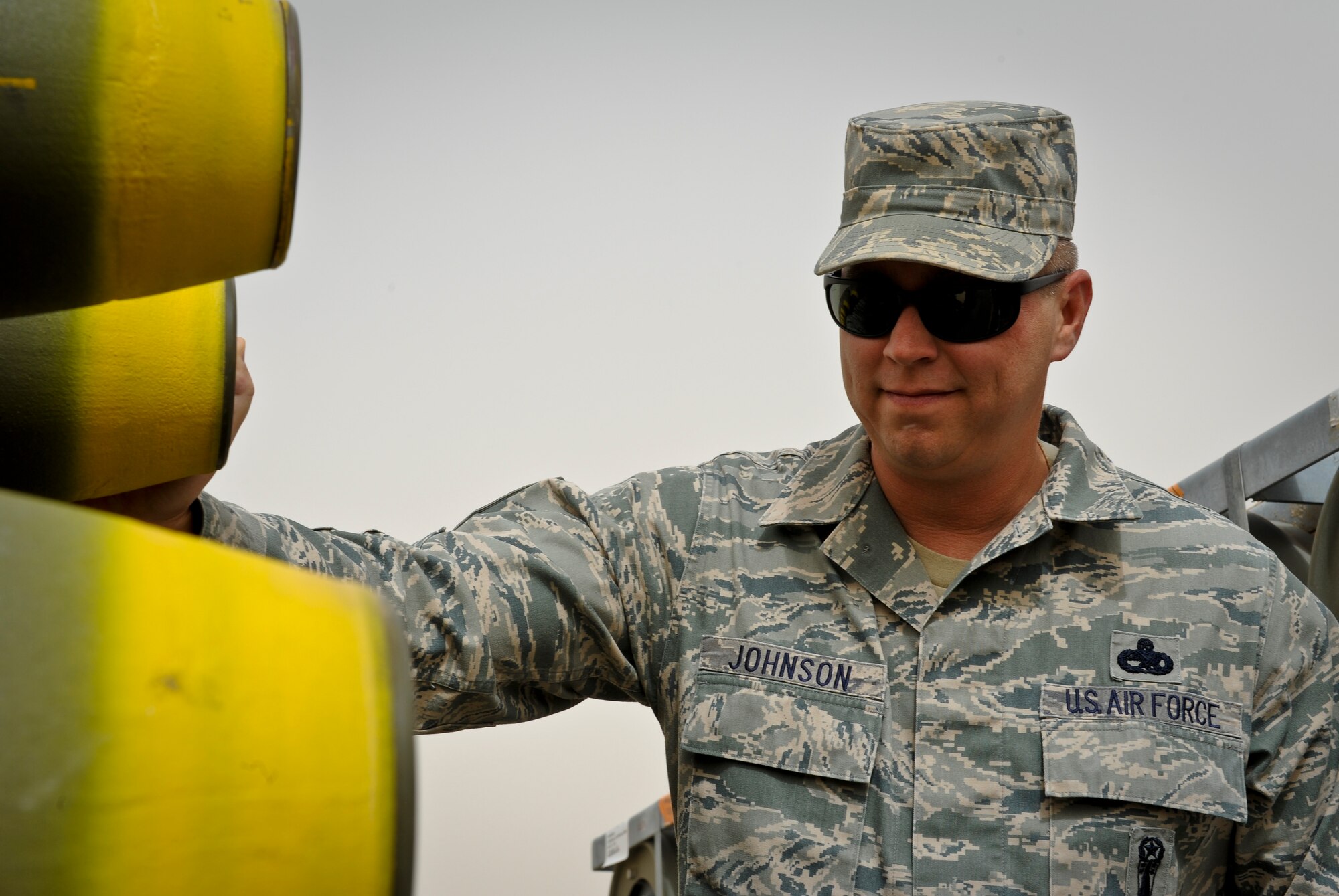 Master Sgt. Christopher Johnson inspects munitions stored at the 379th Air Expeditionary Wing in Southwest Asia, June 11, 2013. Johnson is the 379th AEW weapons safety manager currently serving a one year remote tour. (U.S. Air Force photo/Senior Airman Benjamin Stratton)