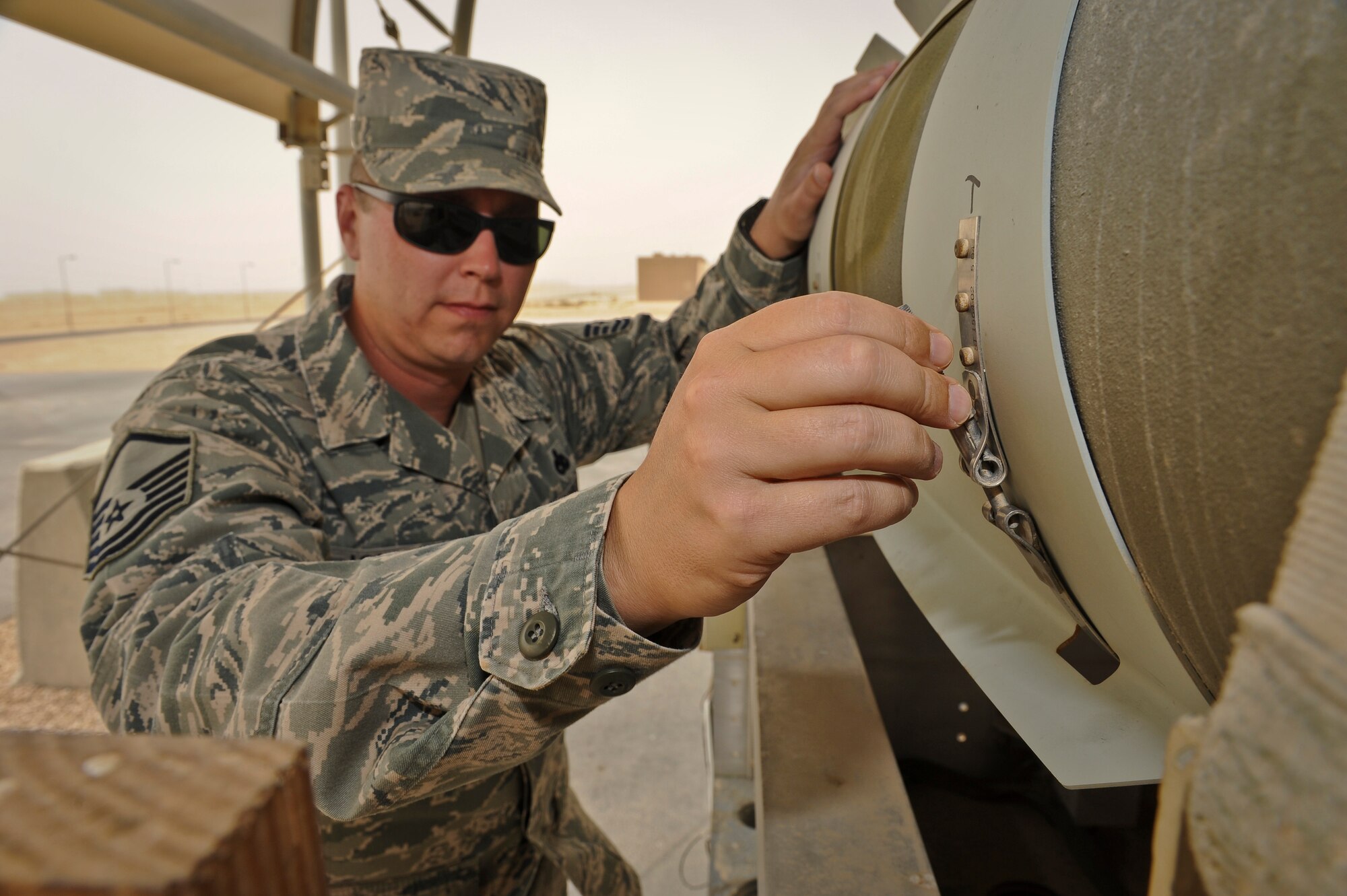 Master Sgt. Christopher Johnson inspects munitions stored at the 379th Air Expeditionary Wing in Southwest Asia, June 11, 2013. Johnson is the 379th AEW weapons safety manager currently serving a one year remote tour. (U.S. Air Force photo/Senior Airman Benjamin Stratton)