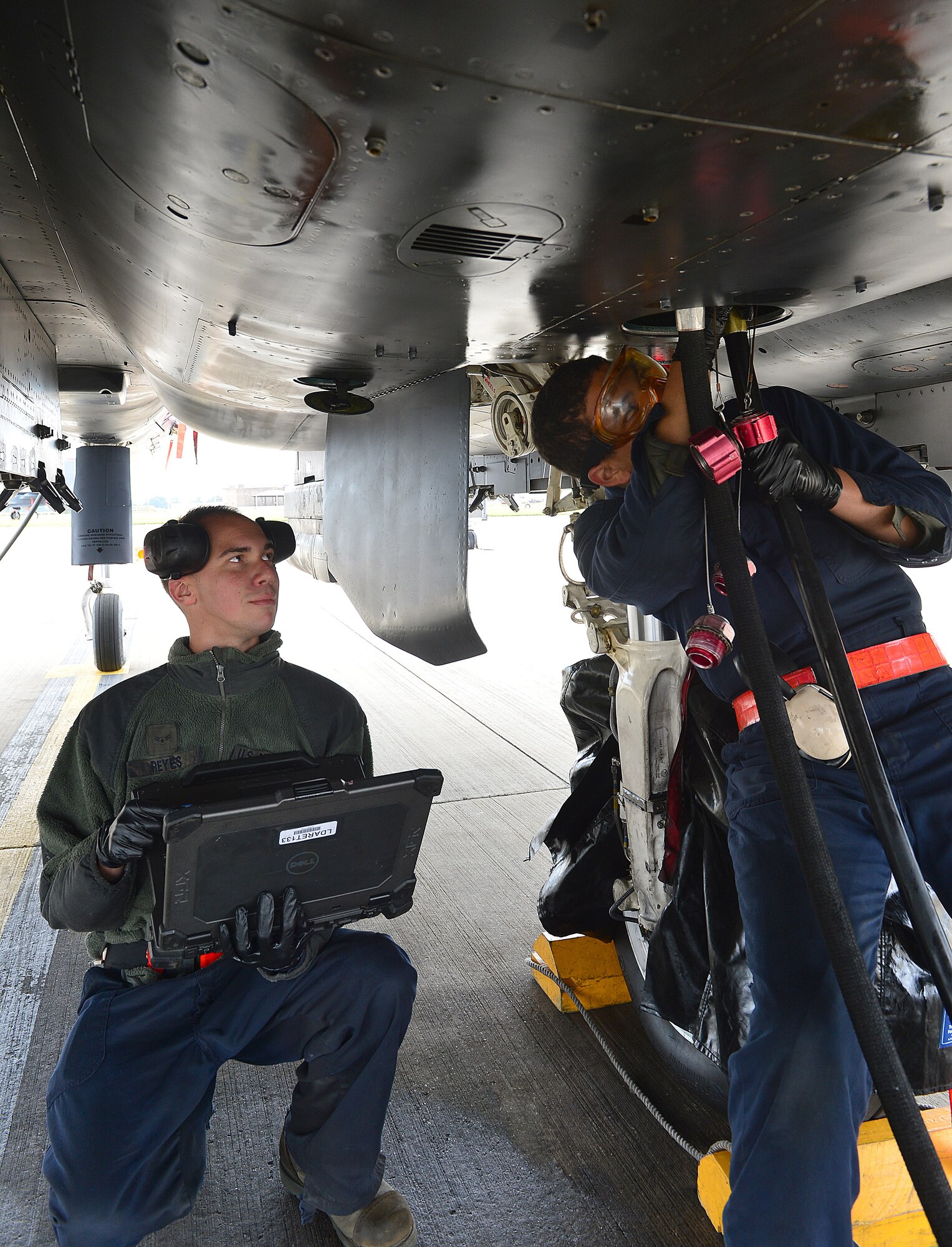 ROYAL AIR FORCE LAKENHEATH, England – Airmen 1st Class Isaiah Freeman (right) and Alexander Reyes, 48th Aircraft Maintenance Squadron crew chiefs, connect an F-15E Strike Eagle hydraulic test stand to a utility system  during a Phase I  exercise June 10, 2013. RAF Lakenheath “deployed” more than 450 Airmen and generated aircraft sorties. The Airmen were maintaining proficiency at generating sorties for deployment within 96 hours. (U.S. Air Force photo by Staff Sgt. Stephanie Mancha)