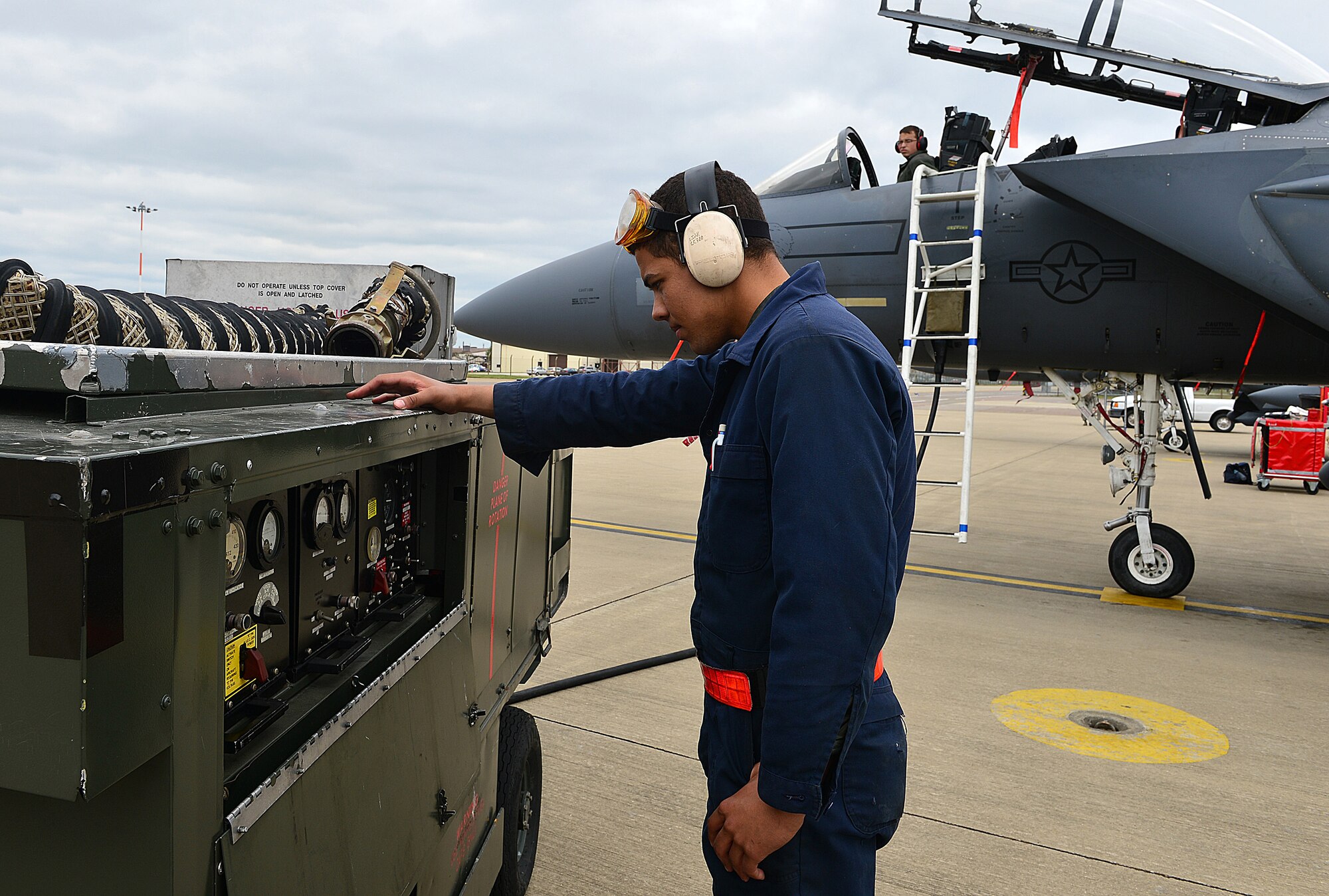 ROYAL AIR FORCE LAKENHEATH, England –Airman 1st Class Isaiah Freeman (front) and Senior Airman Devin Bartlett, 48th Aircraft Maintenance Squadron crew chiefs, lift the tail hook of an F-15E Strike Eagle to perform maintenance on the arresting gear during a Phase I exercise June 10, 2013. RAF Lakenheath “deployed” more than 450 Airmen and generated aircraft sorties. The Airmen were maintaining proficiency at generating sorties for deployment within 96 hours. (U.S. Air Force photo by Staff Sgt. Stephanie Mancha)