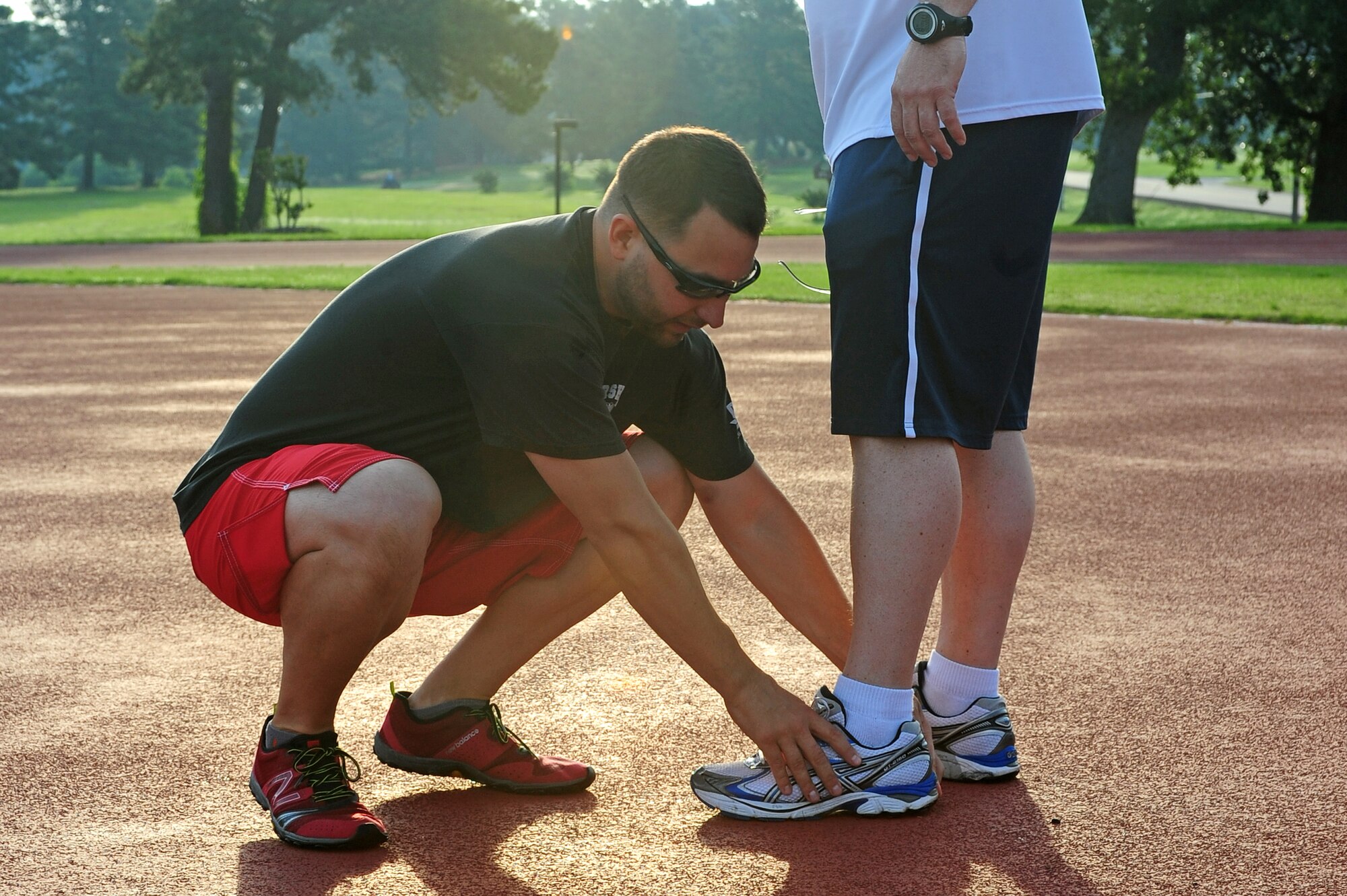 Joe Gonzalez, 4th Aerospace Medicine Squadron health and wellness center physiologist, checks for wear and tear on shoes worn by U.S. Air Force Master Sgt. Dave Sutton, 916th Aircraft Maintenance Squadron avionics section chief, during a running fundamentals class at Seymour Johnson Air Force Base, N.C., June 12, 2013. The next running fundamentals class will be held June 19, 2013 at 7 a.m. at the quarter-mile track. (U.S. Air Force photo by Airman 1st Class John Nieves Camacho/Released)