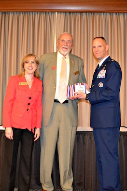 New York Air National Guard Lt. Col. Edward Cook (right) accepts the Leadership Greater Syracuse (LGS) Alumni Achievement Award from Ms. Pam Brunet, LGS Executive Director and Mr. William Sanford, LGS Chairman during a ceremony held on on April 24, 2013.  Lt. Col. Cook is the Logistrics Readiness Squadron Commander for the 174th Attack Wing, Hancock Field Air National Guard Base, Syracuse, New York, and a LGS 2010 graduate.  (photo by New York Air National Guard Lt. Col. Catherine Hutson/Released).