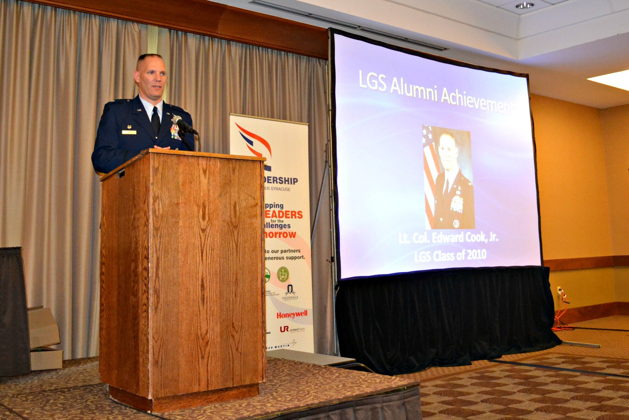 New York Air National Guard Lt. Col. Edward Cook addresses over a hundred Central New York community leaders during his acceptance speech for the Leadership Greater Syracuse Alumni Achievement Award presented during a ceremony held on April 24, 2013.  Lt. Col. Cook serves as the Logistrics Readiness Squadron Commander for the 174th Attack Wing, Hancock Field Air National Guard Base, Syracuse, New York.  (photo by New York Air National Guard Lt. Col. Catherine Hutson/Released).