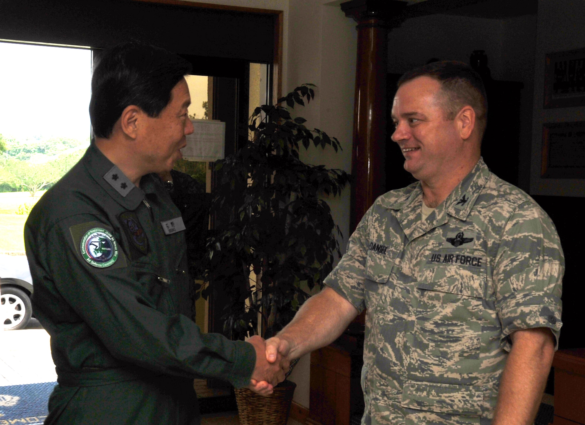 U.S. Air Force Col. Brian McDaniel, 18th Wing vice commander, greets Japan Air Self Defense Force Lt. Gen. Kozo Ishino, Air Rescue Wing commander, at the 18th Wing headquarters building on Kadena Air Base, Japan, June 12, 2013. Ishino and JASDF official members visited the 18th Wing headquarters first before touring several rescue squadron facilities to learn about their missions. (U.S. Air Force photo by Naoto Anazawa/Released)