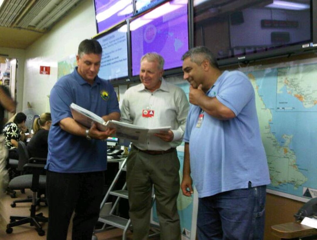 Pete Gitto, USACE-Pacific Ocean Division’s  regional logistics planner (center), reviews response actions with Gary Greenly,  chief of Logistics for Hawaii State Civil Defense (left);  and Chris Lupenui, chief of the state Logistics Warehouse, at the Emergency Operations Center for Exercise Makani Pahili 2013.  Pacific Ocean Division’s Readiness and Contingency Operations Division supported the annual hurricane preparation exercise, which was coordinated by the state Civil Defense and the Hawaii National Guard. 