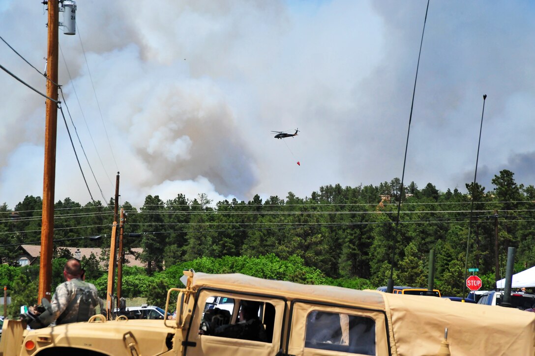 Colorado Army National Guard and Fort Carson, Colo., aviation assets provide firefighting assistance during the Black Forest fire in El Paso County, Colo., June 12, 2013. UH-60 Black Hawk and CH-47 Chinook helicopters are being used to fight the fire.