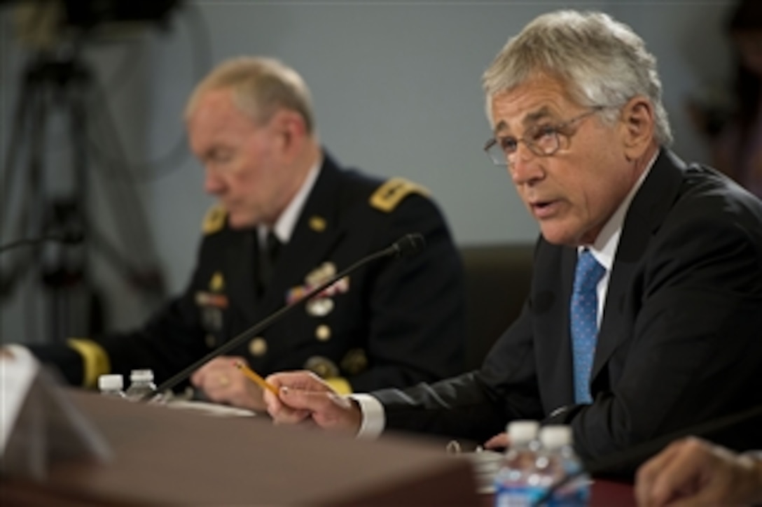 Secretary of Defense Chuck Hagel reads his opening statement as he testifies before the House of Representatives Committee on the Budget in the Cannon House Office Building, Washington, D.C., on June 12, 2013.  Chairman of the Joint Chiefs of Staff Gen. Martin E. Dempsey joined Hagel in defending the president’s request for $526.6 billion for the Defense Department’s fiscal year 2014 budget.  