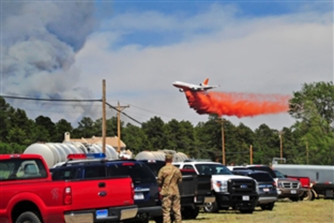 Colorado Army National Guard and Fort Carson, Colo., aviation assets provide firefighting assistance during the Black Forest fire in El Paso County, Colo., June 12, 2013. UH-60 Black Hawk and CH-47 Chinook helicopters are being used to fight the fire.