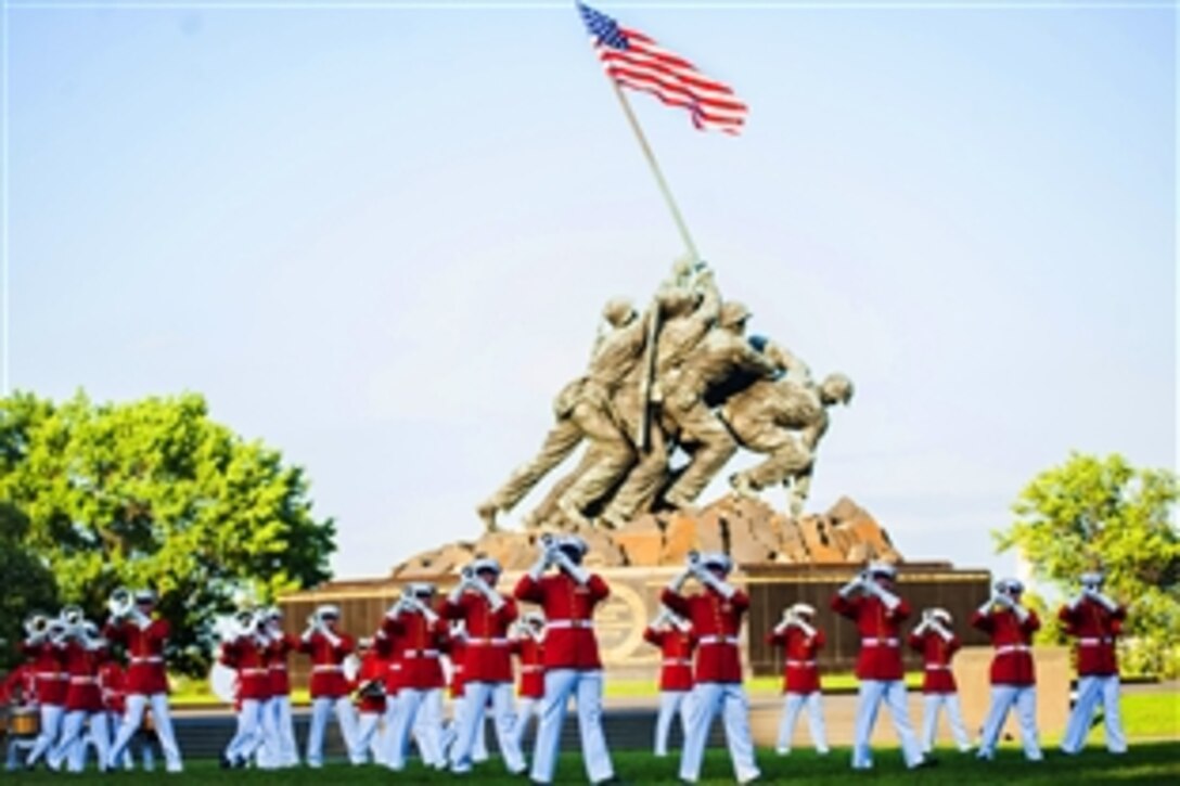 The U.S. Marine Drum & Bugle Corps performs during a sunset parade at the Marine Corps War Memorial in Arlington, Va., June 11, 2013. 
