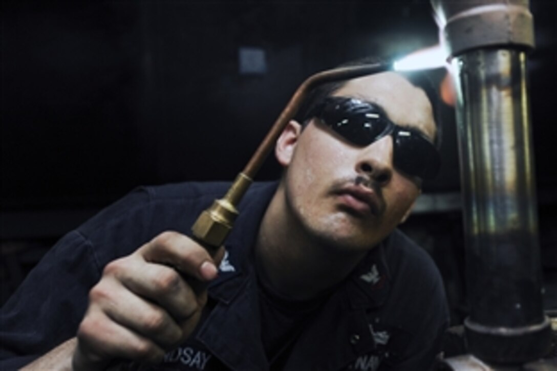 U.S. Navy Petty Officer 2nd Class Jessie Lindsay brazes a pipe aboard the USS Nimitz underway in the Indian Ocean, June 10, 2013. The Nimitz Carrier Strike Group deployed to the U.S. 5th Fleet area of responsibility for maritime security operations and cooperation efforts.