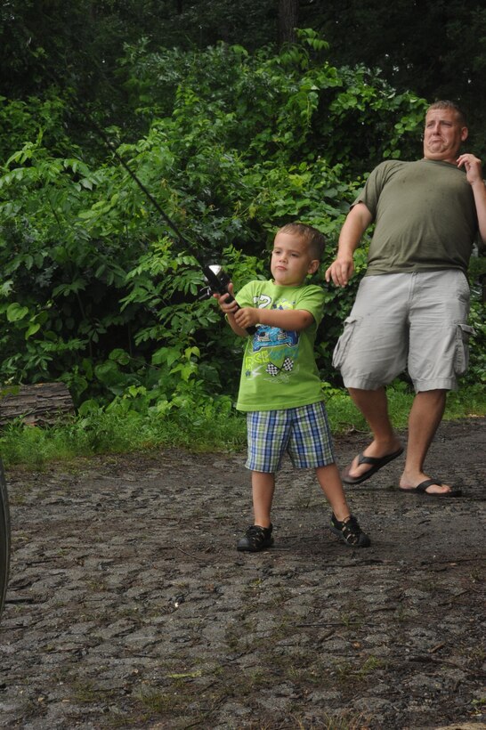 Benjamin, 3 years old, casts a fishing line as his dad, Sgt. Jason Hodge, avoids getting hooked during the Commander's Snakehead Fishing Tournament aboard Marine Corps Base Quantico on June 8, 2013. Over a dozen teams competed during the 24-hour tournament.