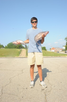 Victor Lenske, Marine Science student at the University of South Carolina, holds his catch outside of Lejeune Hall, aboard Marine Corps Base Quantico on June 8, 2013. Neglecting sleep, Lenske fished all night, catching his biggest fish at 4:00 a.m., on Saturday.
