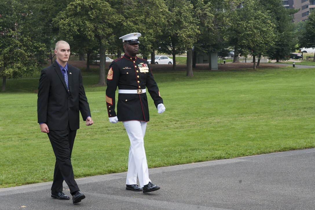 Daran Wankum, the most recent honorary Marine in Marine Corps history, and 1st Sgt. Charles Peoples, Marine Barracks Washington, D.C., Guard Company first sergeant, march up to the Marine Corps War Memorial during a wreath-laying ceremony for Wankum in Arlington, Va., June 13. Wankum was named an honorary Marine on June 11 due to an illness that came up during the enlistment process that prevented him from starting recruit training. He is currently in Washington as a special guest of the commandant of the Marine Corps and the Barracks.
