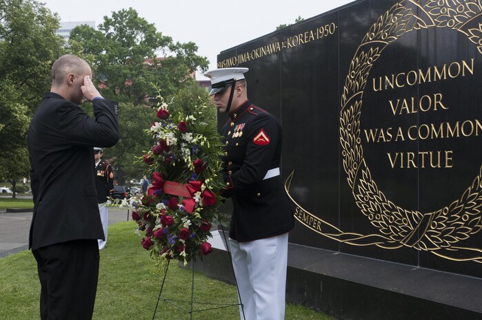 Daran Wankum, the most recent honorary Marine in Marine Corps history, salutes as a wreath is laid at the Marine Corps War Memorial during a ceremony for Wankum in Arlington, Va., June 13. Wankum was named an honorary Marine on June 11 due to an illness that came up during the enlistment process that prevented him from starting recruit training. He is currently in Washington as a special guest of the commandant of the Marine Corps and the Barracks.