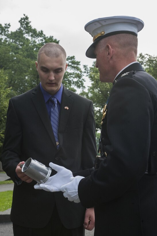 Daran Wankum, the most recent honorary Marine in Marine Corps history, is presented with an official Marine Barracks Washington, D.C, pewter mug from Col. Christian G. Cabaniss, Barracks commanding officer, after a wreath-laying ceremony for Wankum at the Marine Corps War Memorial in Arlington, Va., June 13. Wankum was named an honorary Marine on June 11 due to an illness that came up during the enlistment process that prevented him from starting recruit training. He is currently in Washington as a special guest of the commandant of the Marine Corps and the Barracks.