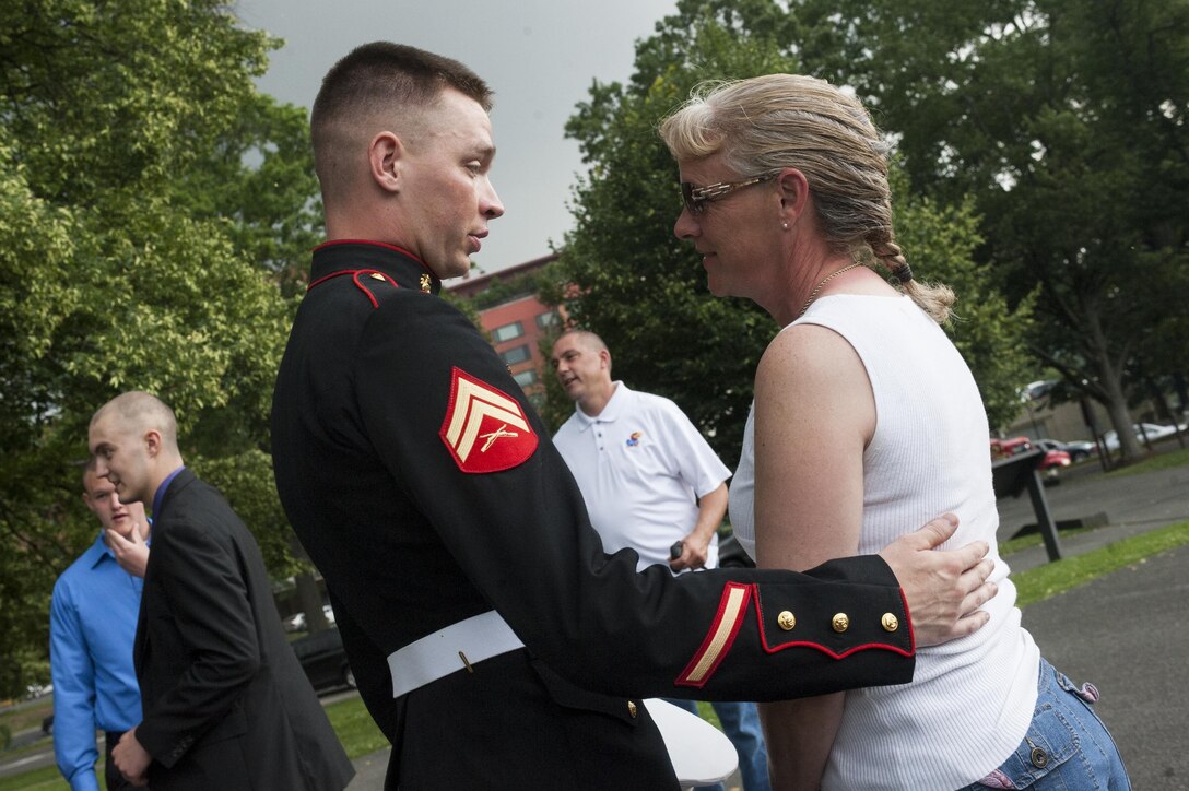 Cpl. Jack Woodworth, Marine Barracks Washington, D.C., ceremonial firing party noncommissioned officer in charge, talks to Cheryl Wankum, mother of Daran Wankum, the most recent honorary Marine in Marine Corps history, after a wreath-laying ceremony for Daran Wankum at the Marine Corps War Memorial in Arlington, Va., June 13. Wankum was named an honorary Marine on June 11 due to an illness that came up during the enlistment process that prevented him from starting recruit training. He is currently in Washington as a special guest of the commandant of the Marine Corps and the Barracks.