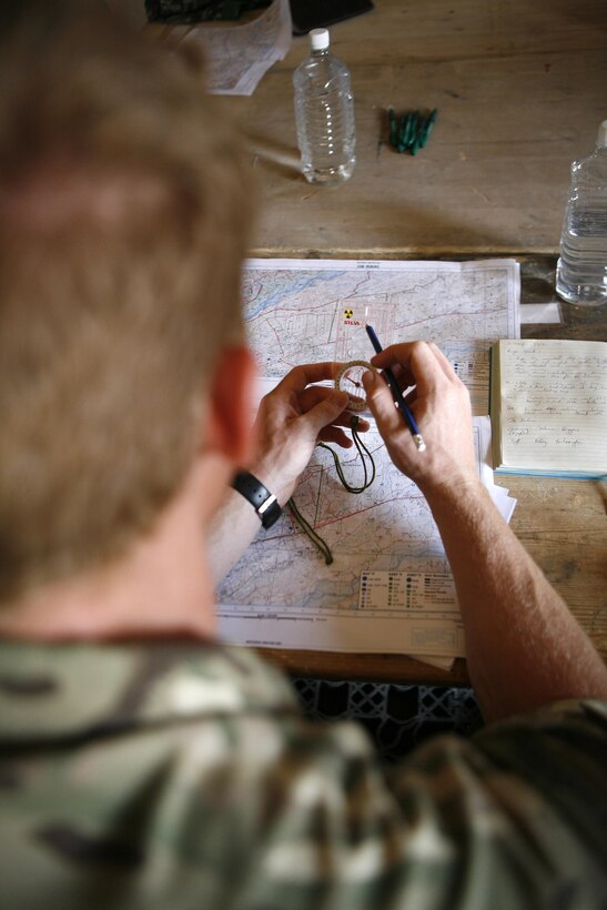 Royal Engineers Capt. Selwyn Fisher, an engineer from 22 Engineer Regiment serving with Kandak Advisor Team 40, teaches Afghan soldiers with Engineering Tolai, 4th Combat Support Kandak, 3rd Brigade, 215th Corps, how to read maps during a class June 5, 2013, at Patrol Base Sparta, here. The tolai, or company, was the last 215th Corps tolai receiving Security Forces Assistance support. Fisher held a lift-off ceremony after the classes to signify the end of hands-on support to the tolai. All SFA provided to units within the 215th Corps is now conducted only at the kandak, or battalion, level and higher.
