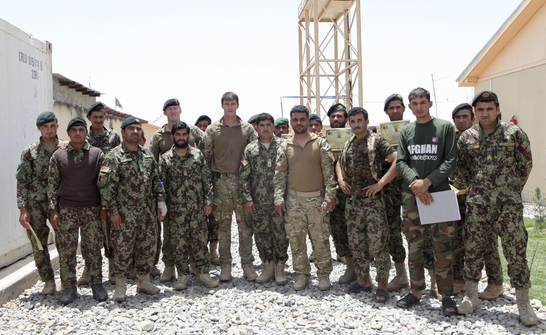 Members of the Kandak Advisor Team 40 pose with members of the Engineering Tolai, 4th Combat Support Kandak, 3rd Brigade, 215 Corps, following a graduation ceremony at Patrol Base Sparta June 5. The ANA soldiers had recently completed an improvised explosive device lane course. (Photo by U.S. Marine Sgt. Bobby J. Yarbrough)