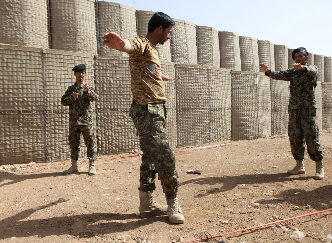 Afghan National Army soldiers practice searching techinques during a searchprocedures class at Patrol Base Sparta June 5. Members of the Kandak Advisor Team 40 held the course to teach members of the Engineering Tolai, 4th Combat Support Kandak, 3rd Brigade, 215 Corps, how to conduct searches at ANA checkpoints. (Photo by U.S. Marine Sgt. Bobby J. Yarbrough)