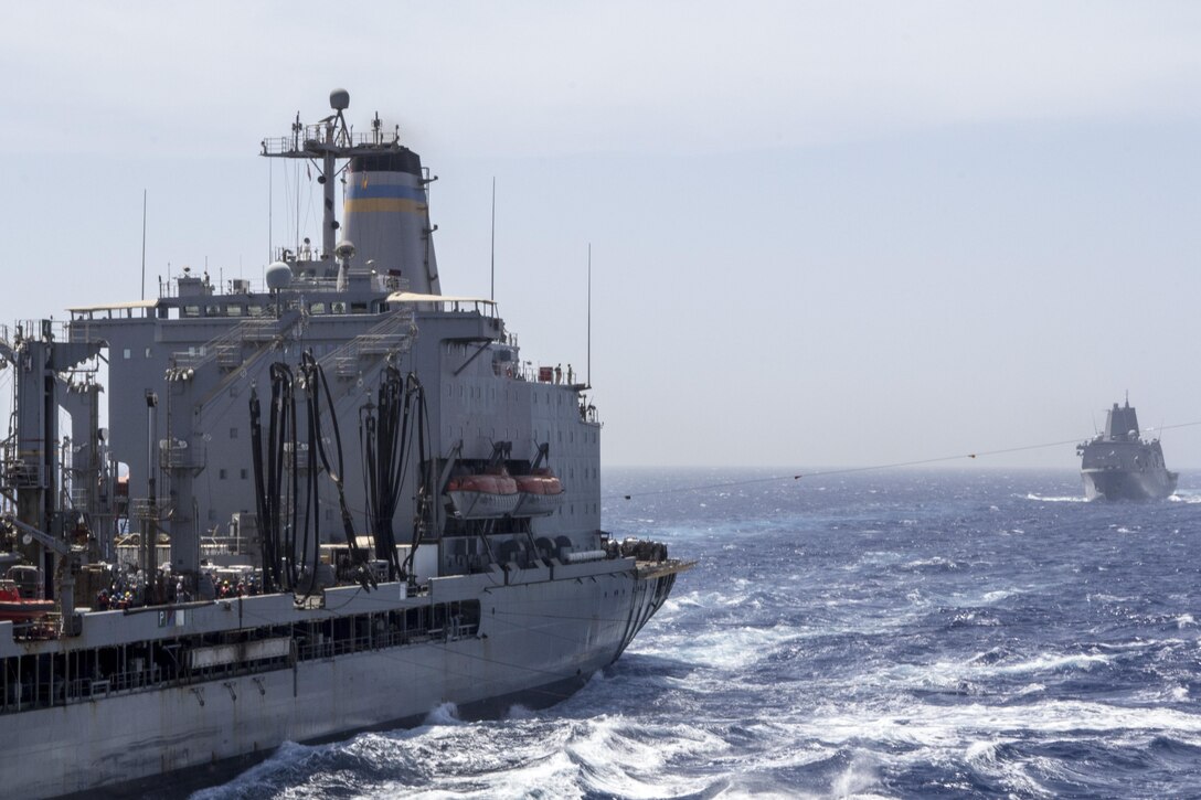 The USS San Antonio (LPD 17) trails behind the USNS Laramie (T-AO-203) while the USS Kearsarge (LHD 3) conducts a resupply at sea, June 14, 2013. The 26th MEU is a Marine Air-Ground Task Force forward-deployed to the U.S. 5th Fleet area of responsibility aboard the Kearsarge Amphibious Ready Group serving as a sea-based, expeditionary crisis response force capable of conducting amphibious operations across the full range of military operations. (U.S. Marine Corps photo by Gunnery Sgt. Michael Kropiewnicki/Released)