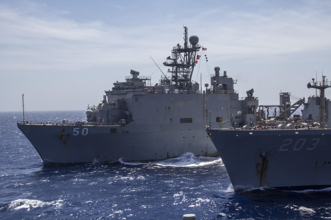 The USS Carter Hall (LSD 50) conducts a resupply at sea with the USNS Laramie (T-AO-203), June 14, 2013. The 26th MEU is a Marine Air-Ground Task Force forward-deployed to the U.S. 5th Fleet area of responsibility aboard the Kearsarge Amphibious Ready Group serving as a sea-based, expeditionary crisis response force capable of conducting amphibious operations across the full range of military operations. (U.S. Marine Corps photo by Gunnery Sgt. Michael Kropiewnicki/Released)