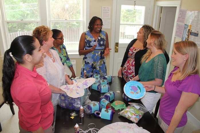 Monique O’Neil (middle), program manager at the Exceptional Family Readiness Program aboard Marine Corps Base Quantico and staff members discuss activity ideas for “Summer Fun Days” at the EFMP House on June 6, 2013. The five events, which will be dispersed throughout the summer, replace the program’s annual week-long summer camp.