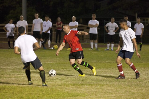 Ryan Harris, a forward for the Headquarters Battalion, controls the ball while looking for an open teammate downfield during a match against Headquarters Battalion at Riseley Field, June 10, 2013. Despite Headquarters Battalion’s greatest efforts, MALS-24 captured the win, 5-2.(U.S. Marine Corps photo by Lance Cpl. Nathan Knapke) 