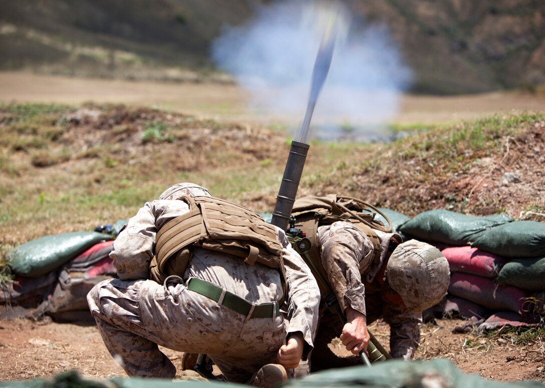 Lance Cpl. Corey Klemcke, a mortarman with weapons platoon, Golf Company, 2nd Battalion, 3rd Marine Regiment, and Lance Cpl. Jared Ninow, a mortarman with 2nd Bn., 3rd Marines, conduct live-fire training for exercise Island Viper at Kaneohe Bay range training facility, June 6, 2013. (U.S. Marine Corps photo by Lance Cpl. Suzanna Lapi)