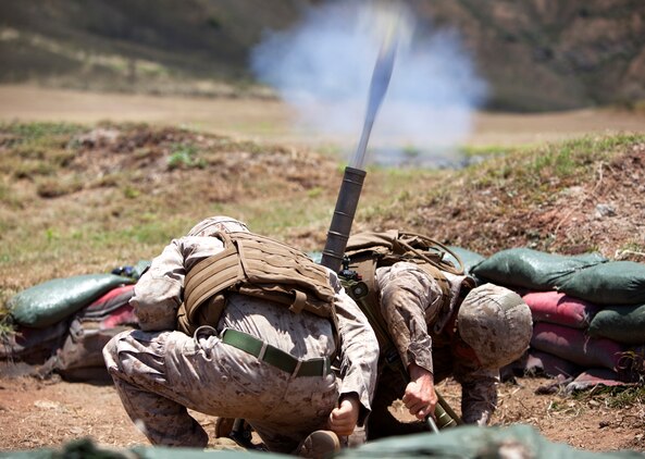 Lance Cpl. Corey Klemcke, a mortarman with weapons platoon, Golf Company, 2nd Battalion, 3rd Marine Regiment, and Lance Cpl. Jared Ninow, a mortarman with 2nd Bn., 3rd Marines, conduct live-fire training for exercise Island Viper at Kaneohe Bay range training facility, June 6, 2013. (U.S. Marine Corps photo by Lance Cpl. Suzanna Lapi)