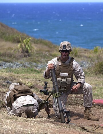 Lance Cpl. Mitchell McGee, a machine gunner with Golf Company, 2nd Battalion, 3rd Marine Regiment, and Lance Cpl. Paul Margeson, a mortarman with weapons platoon, Golf Co., 2nd Bn., 3rd Marines, conduct live-fire training for exercise Island Viper at Kaneohe Bay range training facility, June 6, 2013. (U.S. Marine Corps photo by Lance Cpl. Suzanna Lapi)