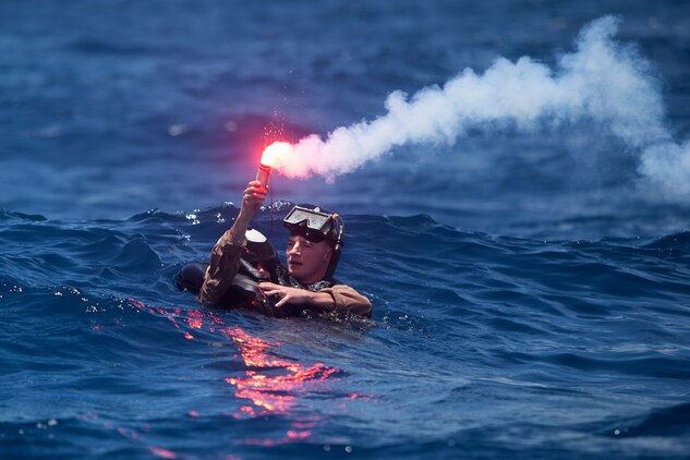 Marines with Marine Aircraft Group 24 dive in to conduct annual mishap drill training in Kaneohe Bay, June 11, 2013. MAG-24 coordinated with Marine Heavy Helicopter Squadron 463, Marine Light Attack Helicopter Squadron 367, Helicopter Antisubmarine Squadron Light 37, Patrol Squadron 9, Marine Corps Air Station Kaneohe Bay, Marine Corps Base Hawaii Waterfront Operations, Federal Fire Department, and the Honolulu Fire Department for this training event. (U.S. Marine Corps photo by Lance Cpl. Suzanna Lapi)