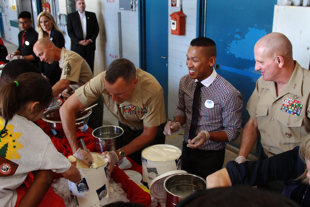 Brig. Gen. Vincent A. Coglianese, middle, SgtMaj. Scott R. Helms, left, and Maj. Gen. Steven W. Busby, far right, serve ice cream to the children and mentors of the Tragedy Assistance Program for Survivors at the air station here during their four-day Good Grief Camp, June 14. The children ate pizza and ice cream as Vice President Joe Biden spoke to them about the hardships they face and coping with the loss of a loved one. Coglianese is the base commanding general and regional authority for five military installations in the Southwestern United States and Helms is his senior enlisted advisor. Busby is the commanding general for the 3rd Marine Aircraft Wing.