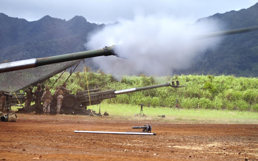 An M777 howitzer launches a 155 mm artillery shell in response to a fire mission given to gun A with Alpha Battery, 1st Battalion, 12th Marine Regiment, during a training exercise at Schofield Barracks, June 11, 2013. The exercise was part of a three-day training exercise called Spartan Fury 13.3, in which the main goal was to ensure the preparedness for providing combat artillery support to 3rd Marine Regiment in their upcoming infantry training exercise.