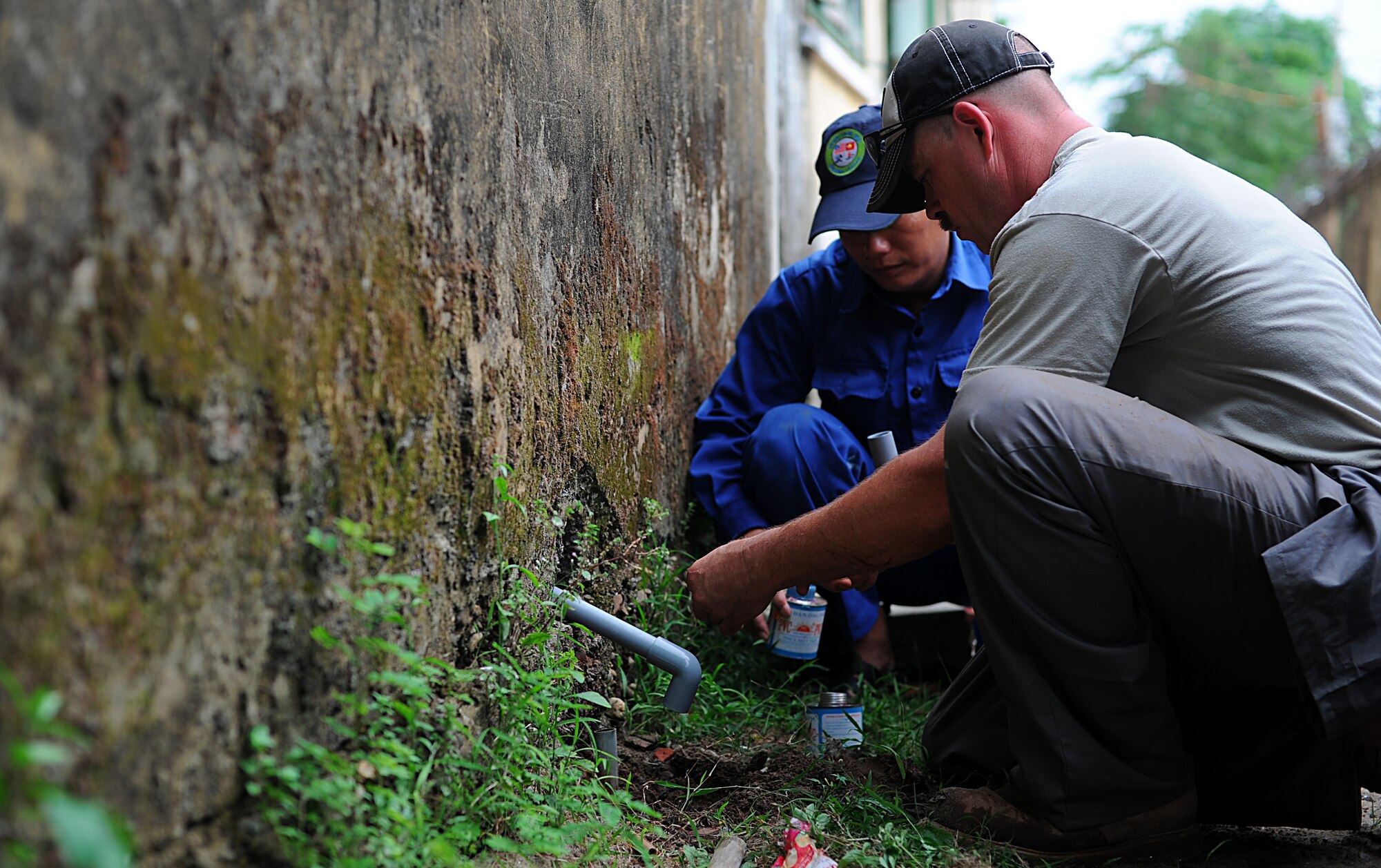 Tech Sgt. Shane Glenzer, a Water Fuels Systems Maintenance specialist from the 142nd Air National Guard Base in Portland Oregon, works with members of the Vietnam People's Army to fix a broken pipe at a school in Dong Hoi, Quang Binh Province, Vietnam, June 12, 2013. Two schools and one medical facility were renovated as part of the Engineering Civil Action Programs for Operation Pacific Angel 13-3. Operation PACANGEL is a joint and combined humanitarian assistance exercise held in various countries several times a year and includes medical, dental, optometry, engineering programs and a variety of subject-matter expert exchanges. (U.S. Air Force photo by Staff Sgt. Sara Csurilla)

