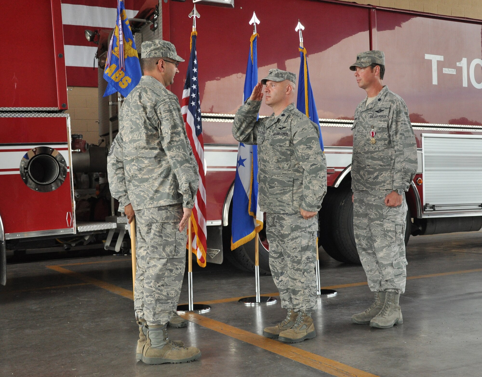 SOTO CANO AIR BASE, Honduras -- Air Force Lt. Col. Ray P. Matherne (center), the 612th Air Base Squadron commander, salutes Air Force Col. Jonathan VanNoord (left), the 612th Theater Operations Group commander, during the 612th change of command ceremony here June 7. Matherne assumed command from Air Force Lt. Col. Robert J. Pedersen (right). The 612 ABS provides air base support to JTF-B and 12th Air Force, which includes air traffic control, logistics, base civil engineering, the fire department, airfield operations and personnel functions.   