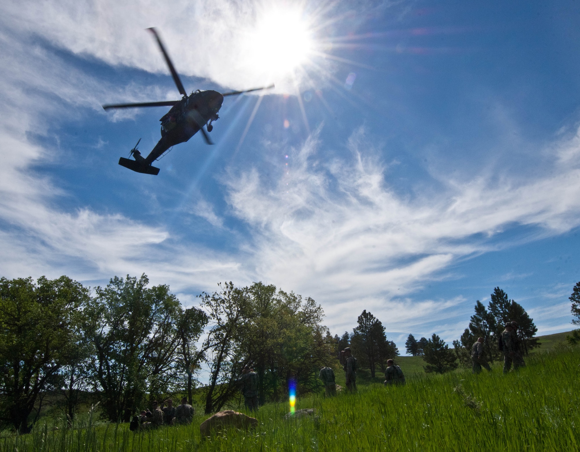 A South Dakota National Guard HH-60 Black Hawk is guided into position during medical evacuation training exercise at the Fort Meade training range in Sturgis, S.D., June 10, 2013. This joint exercise coordinated by Ellsworth Air Force Base survival, evasion, resistance and escape specialists, allowed soldiers and aircrews to practice, experience and better understand joint operations in preparation of future missions downrange. (U.S. Air Force photo by Airman 1st Class Zachary Hada/Released)