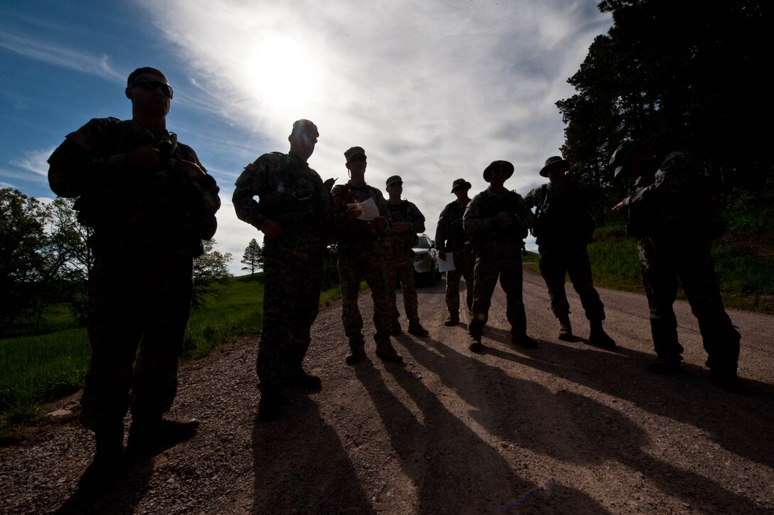 Soldiers from South Dakota National Guard B Company 1-112 prepare for survival, evasion, resistance and escape training during an exercise segment of Golden Coyote coordinated by Air Force SERE specialists from Ellsworth Air Force Base at the Fort Meade training range in Sturgis, S.D., June 10, 2013. The training is designed to teach aircrews and other personnel survival techniques they can use to evade enemy forces while safely signaling friendly forces. (U.S. Air Force photo by Airman 1st Class Zachary Hada/Released)